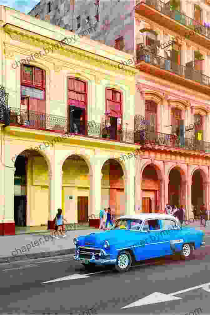 A Bustling Street In Havana, Lined With Colorful Buildings And Vintage Cars All The Way To Havana